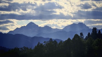 Mountain landscape with silhouettes and clouds in the sky, Slovenia