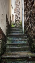 Weathered stone staircase in a narrow alley with historic walls, Loket, Czech Republic