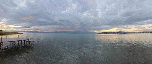 Panoramic view of a lake at sunset, with a jetty in the foreground, Lake Ohrid, North Macedonia