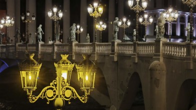 Lighting on bridge with statues at night, architectural highlight, Skopje, North Macedonia