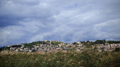 A city on a hill with a wide view of clouds and vegetation below, Ohrid, North Macedonia