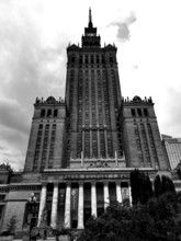 Majestic skyscraper Palace of Culture in historical style in black and white under cloudy sky,