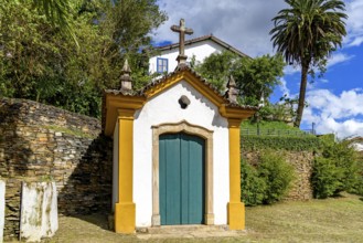 Historic 18th century chapel with a stone crucifix. Passo da Ponte Seca in the city of Ouro Preto