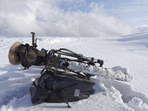 A bicycle is lying in the snow in a cold winter landscape, Upper Franconia, Germany