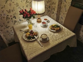 A cozy table with flowers and breakfast in a cozy room, Poland