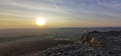 Breathtaking sunset over a vast landscape seen from a rocky outcrop, Staffelberg, Upper Franconia