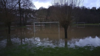 Football field is under water, surrounded by trees, snow melt high water, Kronach, Upper Franconia