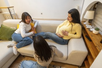 Pregnant woman resting on a sofa. Communicating with her friends. Receiving support and comfort