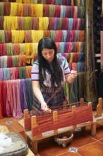 Maya woman, 42 years old, places cotton in a weaving frame, traditional craft in a woman's