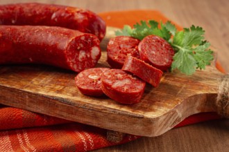Spicy Chorizo sausage, on a cutting board, on a wooden table