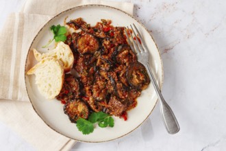 Stewed meat with eggplant is a Georgian dish, on a light background, homemade, no people