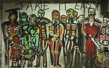 Colourful skeleton-style graffiti artwork with the inscription 'Take It Easy, 'Tbilisi, Georgia