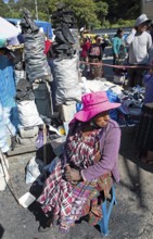 Mayan woman in traditional clothing selling charcoal at the market in Sololá, Highlands, Sololá