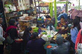 Mayan woman in traditional clothing preparing food, market in Sololá, Highlands, Sololá Department,