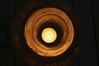 Ice bowl illuminated by a burning tea light, winter, Finland