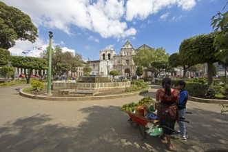 Parque Centroamérica or Parque Central, a Mayan woman in traditional dress selling oranges, in the
