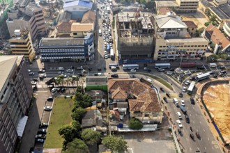 Bustling street scene in the city center with lots of cars and surrounding buildings