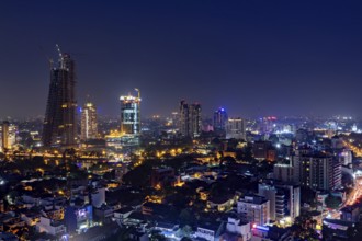 Illuminated nighttime skyline with numerous skyscrapers and sparkling city lights