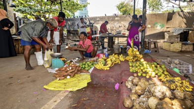 Lively open-air market with tropical fruit and vegetable shops