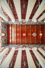 Frog's-eye view: Ubosot (ordination hall) with columns (Sao) and richly decorated ceiling (Phra