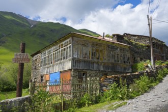 Rustic house on a mountainside under a cloudy sky, traditional house, Ushguli, Shibiani district,
