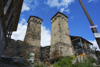 Two old stone towers under a cloudy sky, defensive towers, Ushguli, Ushguli, Shibiani district,