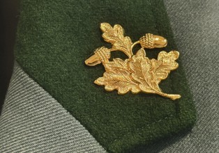 Traditional uniform of the shooting guild Rapen with golden acorn leaf as hunter's badge, detail,