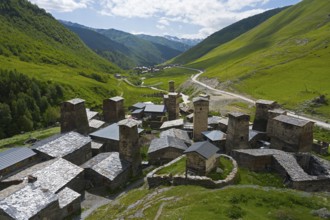 Village with a variety of towers and roofs in a green mountain backdrop, defensive towers, Ushguli,