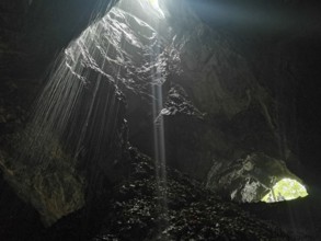 A narrow beam of light illuminates the mystical atmosphere of the cave, High Tatras, Poland