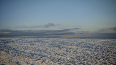 Snow-covered landscape under clear sky at twilight, Rennsteig