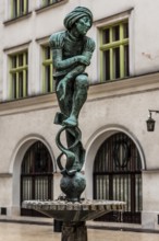 Fountain with student statue in historic clothing, Krakow, Poland
