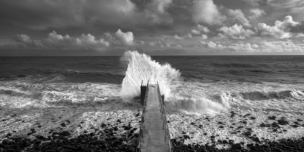 Pier during storm, bridge with waves, Atlantic Ocean, Madeira, Portugal