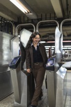 Young businesswoman with glasses and professional attire entering a new york city subway station