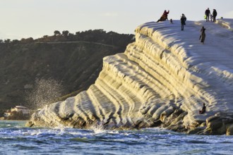 Terraced chalk cliffs Scala dei Turchi, walkers on Turkish steps, Realmonte, Agrigento, Sicily,