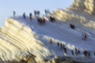 Terraced chalk cliffs Scala dei Turchi, anonymous walkers on Turkish steps, illustration, motion