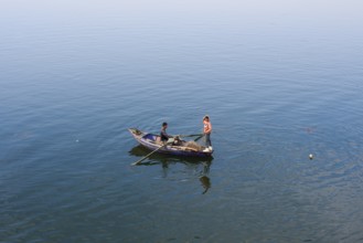 Boys in a rowboat fishing on the Nile, Luxor, Egypt