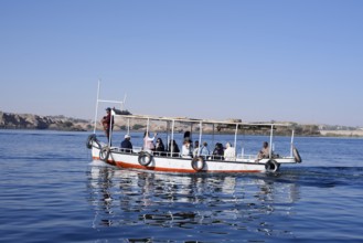 Sightseeing boat with tourists on Lake Nasser, Aswan, Egypt