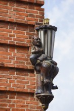 Lantern and sculpture on a house wall, Plön, Holsteinische Schweiz nature park Park,