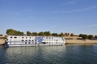 Nile cruise ship Radamis II at pier and double temple of Kom Ombo, Kom Ombo, Egypt