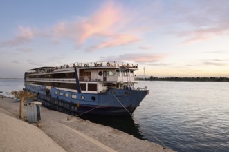 Nile cruise ship at a pier at dawn, Esna, Egypt