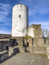 View of castle tower Bergfried made of stone masonry of castle ruins of medieval Höhenburg