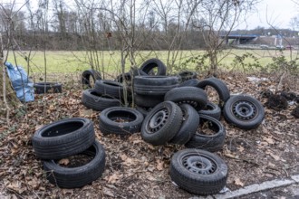 Illegally disposed of car tires and other trash, on a side street in Duisburg-Kaiserberg, North