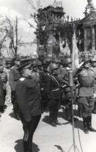 Soviet soldiers salute the destroyed Reichstag in Berlin, Germany, June 1945