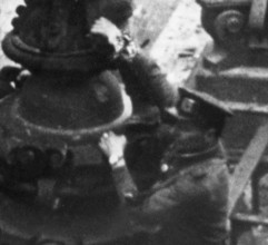 Excerpt from the photo: At the Berlin Reichstag, May 2, 1945, three Soviet soldiers hoist the flag