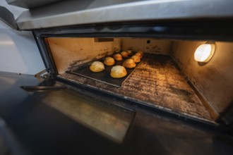 Baking tray with rolls in the oven during the baking process, baking rolls, Haselstaller Hof,