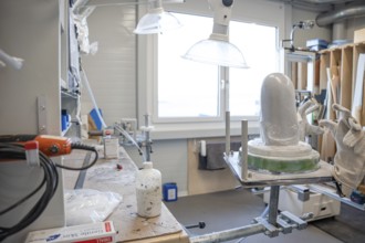 Workshop area with plaster and tools for making prostheses under lamps, medical supply store