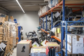 Storage room with shelves full of wheelchairs and boxes, industrial and organized, medical supply