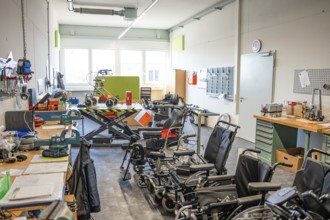 Workshop with wheelchairs and rehabilitation equipment, bright and functional atmosphere, medical