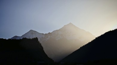 Silhouette of mountains at dawn with soft light and calm atmosphere, Mestia, Georgia