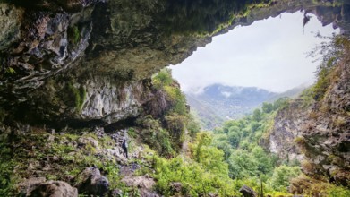 View from a cave of a green mountain landscape with cloudy sky, Debed Canyon, Armenia
